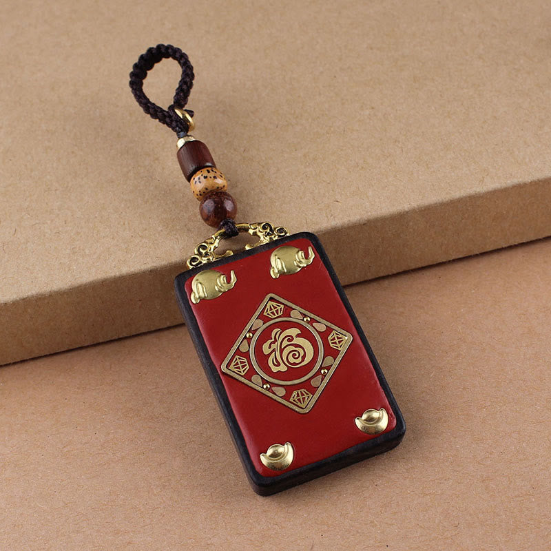 Hand-Carved Ebony Wood Red String Keyring with Symbolic Motifs