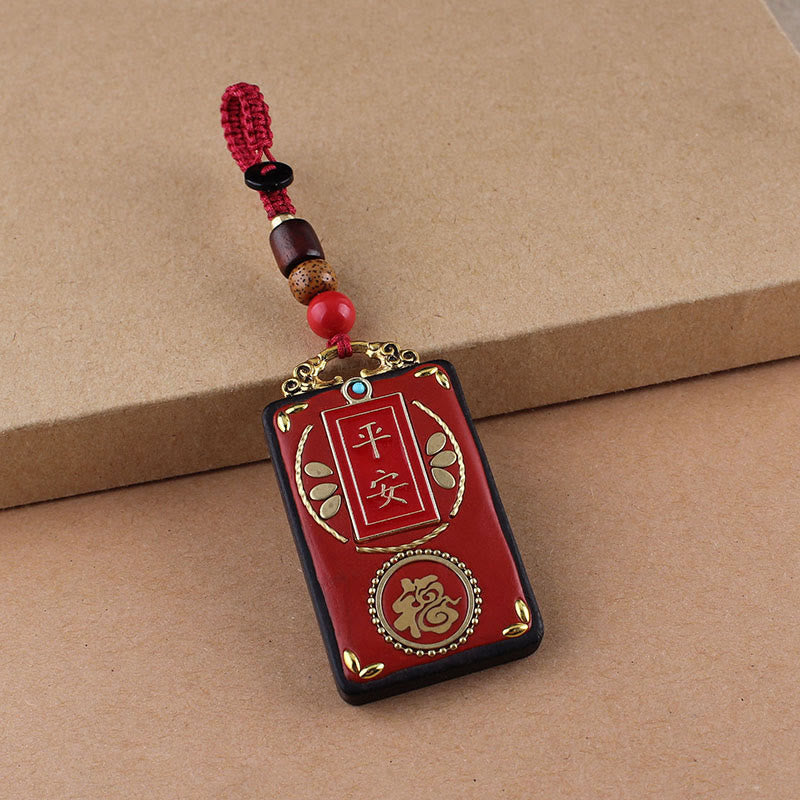 Hand-Carved Ebony Wood Red String Keyring with Symbolic Motifs