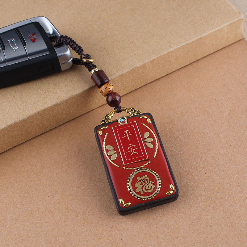 Hand-Carved Ebony Wood Red String Keyring with Symbolic Motifs